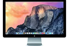 Srebrny 27-calowy monitor Apple Thunderbolt Display w czarnej szklanej ramce, na ekranie pulpit macOS z widokiem gór
